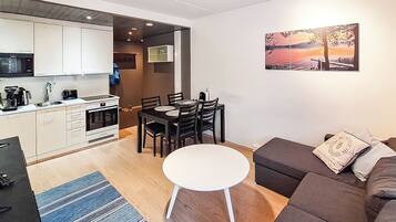 A modern apartment with a kitchen, dining area, and living room.