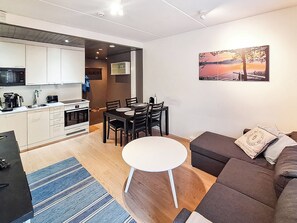 A modern apartment with a kitchen, dining area, and living room.