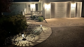 A residential house with a garage, a front porch, and a driveway. - Yellowstone Country Home - Launchpad for a trip of a lifetime!  (Livingston)