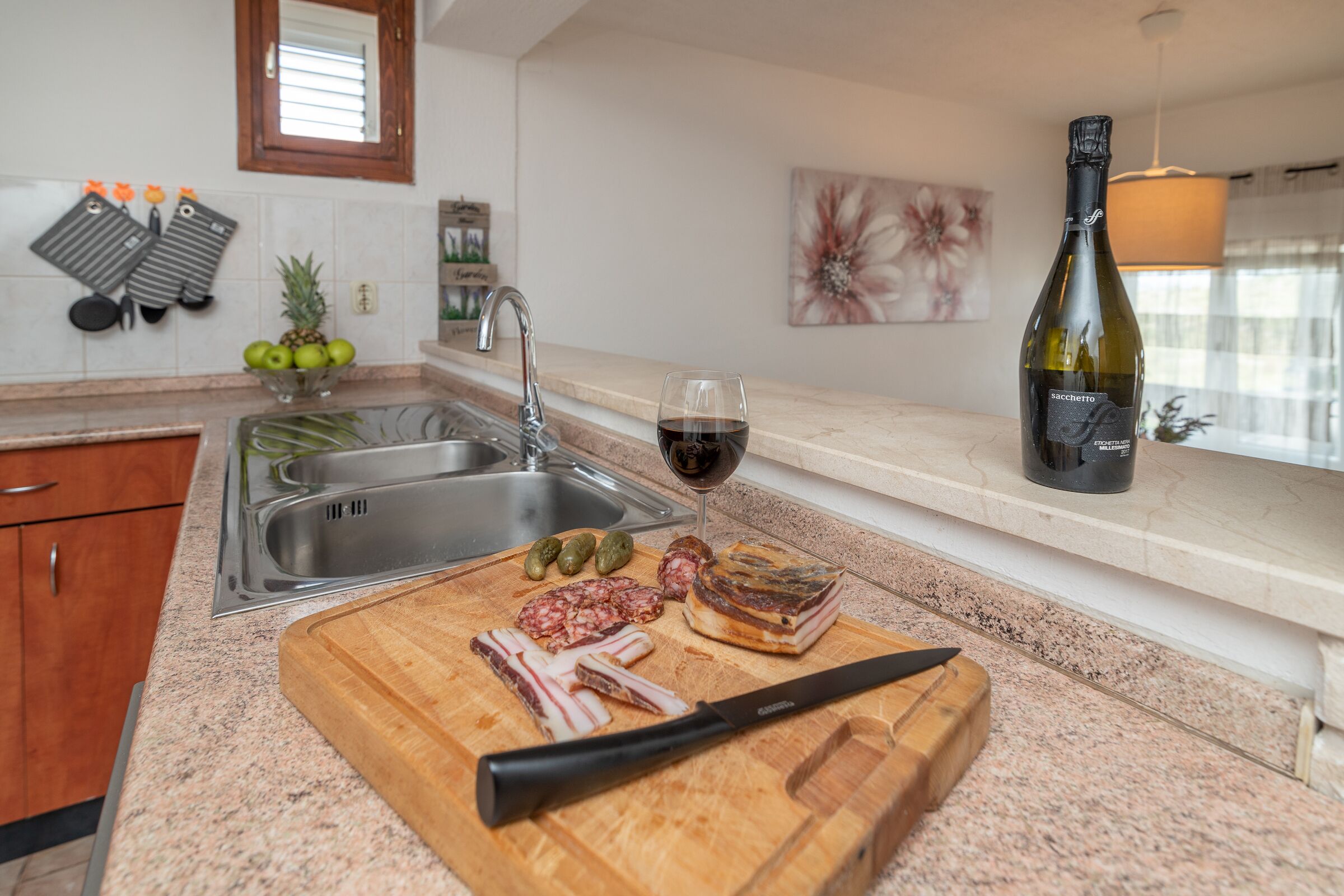 A kitchen with a cutting board, knife, and food items.