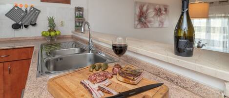 A kitchen with a cutting board, knife, and food items.