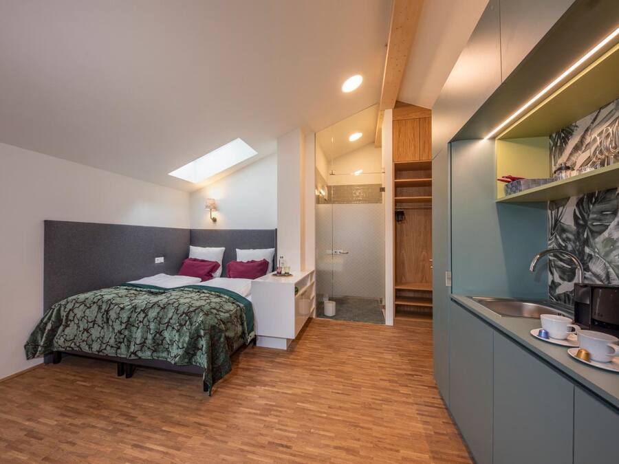 A modern bedroom with a bed, bedside table, and a built-in wardrobe.