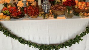 A table with candles, flowers, and fruits. - Welcome to Lush Tuscany and Beautiful Villa Adriano (Borgo a Mozzano)