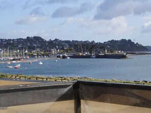 A harbor with boats, a pier, and a town in the background.