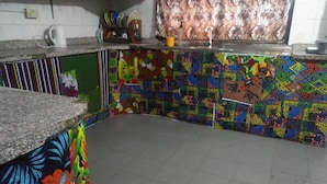A kitchen with colorful patterned tiles, a granite countertop, and a sink. - Room-the Village Apartments, Gbagada (Lagos)