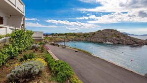 A coastal road leading to a rocky island with a clear blue sky. - Amazing Home in Sveti Juraj With Wifi and 0 Bedrooms (Senj)