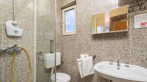 A bathroom with a toilet, bidet, sink, and a window. - Beautiful Apartment in Omisalj With 1 Bedrooms and Wifi (Omisalj)