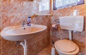 A bathroom with a marble sink, toilet, and a shower area. - Nice Apartment in Liznjan With 1 Bedrooms (Liznjan)