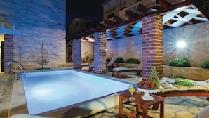 An outdoor swimming pool with lounge chairs and a table with fruit and drinks. - Awesome Home in Novigrad With 4 Bedrooms, Sauna and Wifi (Novigrad)