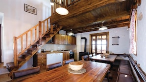 A rustic kitchen with wooden features, a dining area with a wooden table, and a staircase. - Beautiful Home in Hrnjanec With 1 Bedrooms and Wifi (Sveti Ivan Zelina)