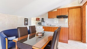 A compact kitchen with wooden cabinets, a microwave, and a coffee maker. - Stunning Home in Porec With Wifi and 2 Bedrooms (Porec)