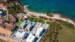 An aerial view of a coastal hotel with multiple buildings, a beach, and clear blue waters. - Amazing Home in Zidarici With Outdoor Swimming Pool, Wifi and 4 Bedrooms (Malinska-Dubasnica)