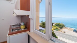 A kitchen with a window overlooking a coastal view. - Nice Home in Podstrana With Wifi and 0 Bedrooms (Podstrana)