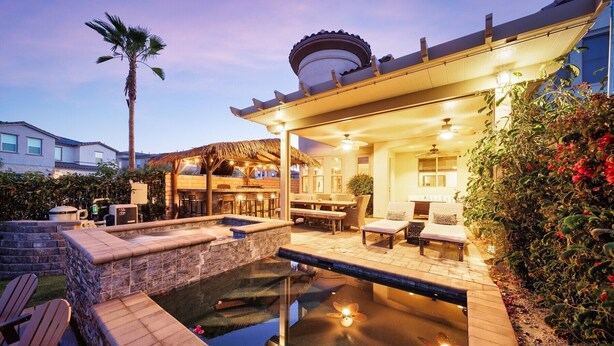 A patio with a pool, outdoor seating, and a covered dining area. - 🏝️Chic villa on the lake! 3 bed 3 bath, Golf, bbq & fun in the sun 🌵🏝️🍦👙 (Indio)