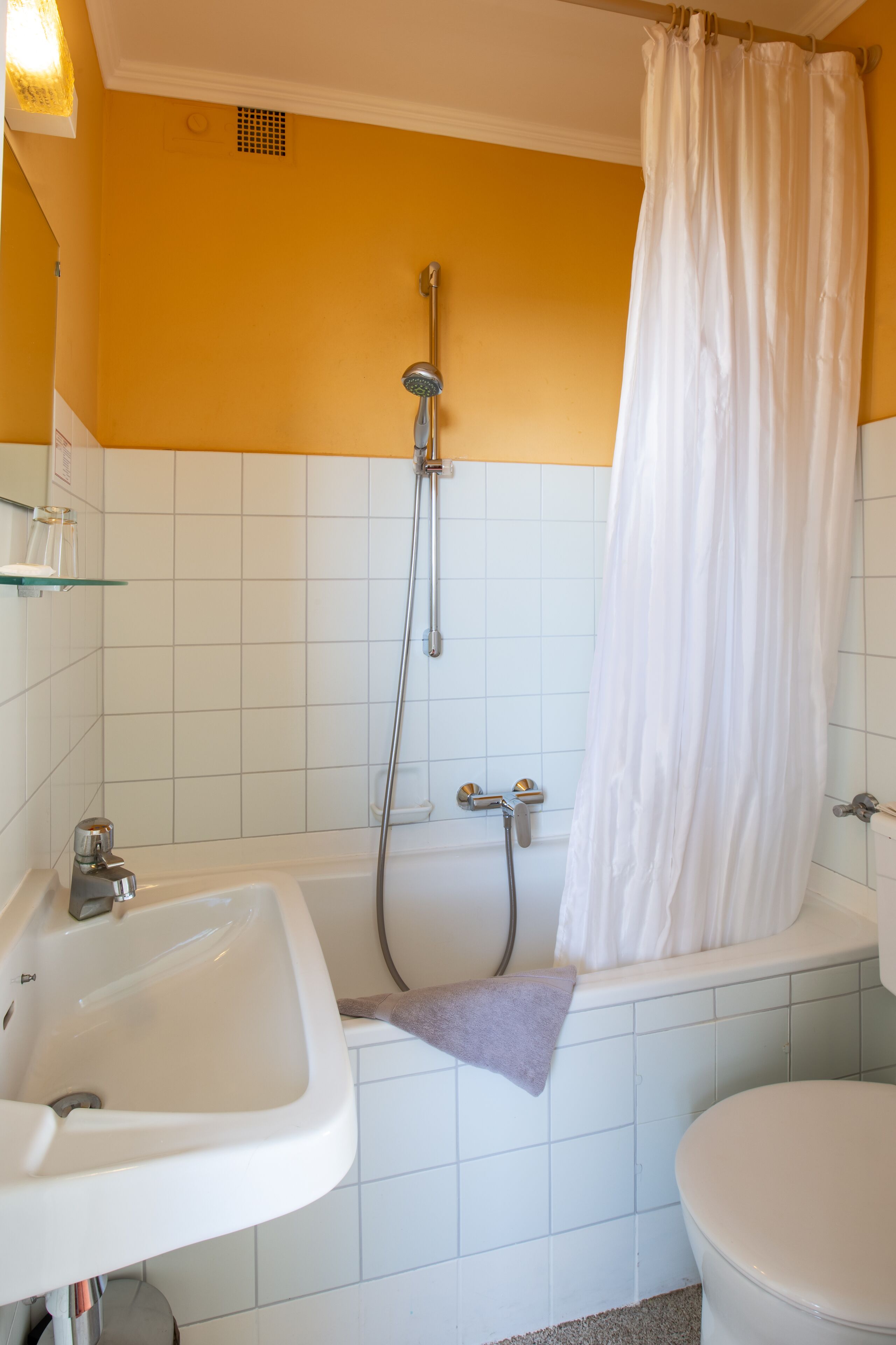 A bathroom with a bathtub, a sink, and a toilet.