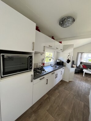 Fridge, coffee/tea maker, electric kettle, cookware/dishes/utensils