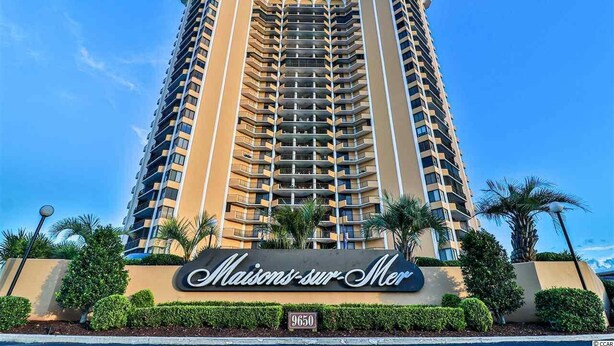 A tall hotel with a sign reading "Maisons-sur-Mer" and the number 9650.