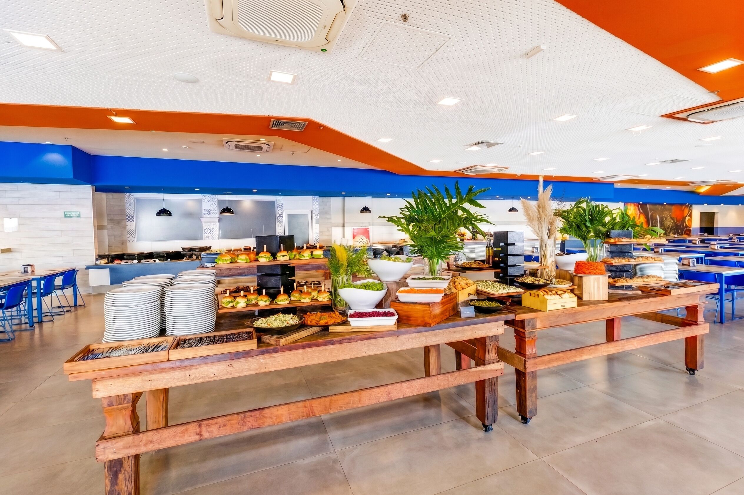 A buffet setup with various food items and a modern interior design.