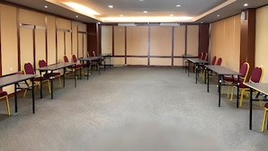 A conference room with tables and chairs, a carpeted floor, and a large window. - All Nite and Day Makassar (Makassar)