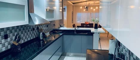 Microwave, dishwasher, coffee/tea maker, cookware/dishes/utensils