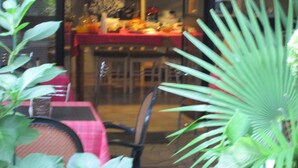 A dining area with a table set for two, surrounded by potted plants. - Ca Grande (Milan)