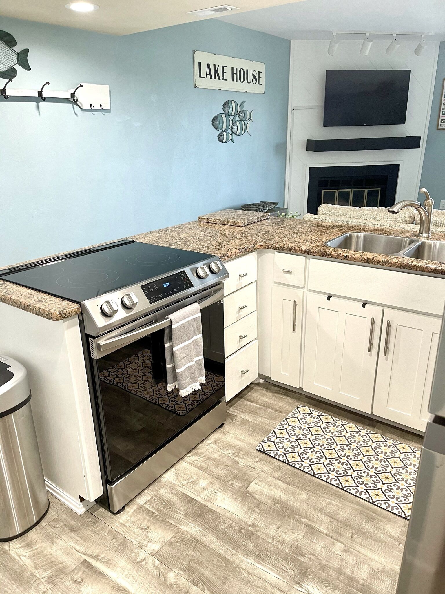 A kitchen with a built-in stove, oven, and a sink.