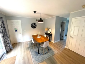 Enjoy meals in this cozy dining area with a wooden table and four chairs.