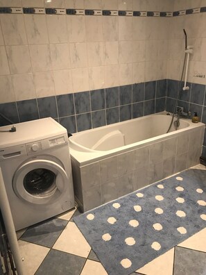 Bathtub, hair dryer, towels, soap