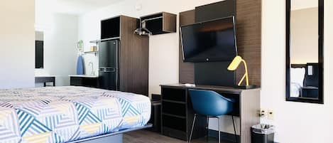 Premium bedding, desk, laptop workspace, blackout drapes