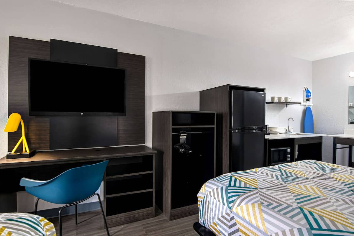 Premium bedding, desk, laptop workspace, blackout drapes