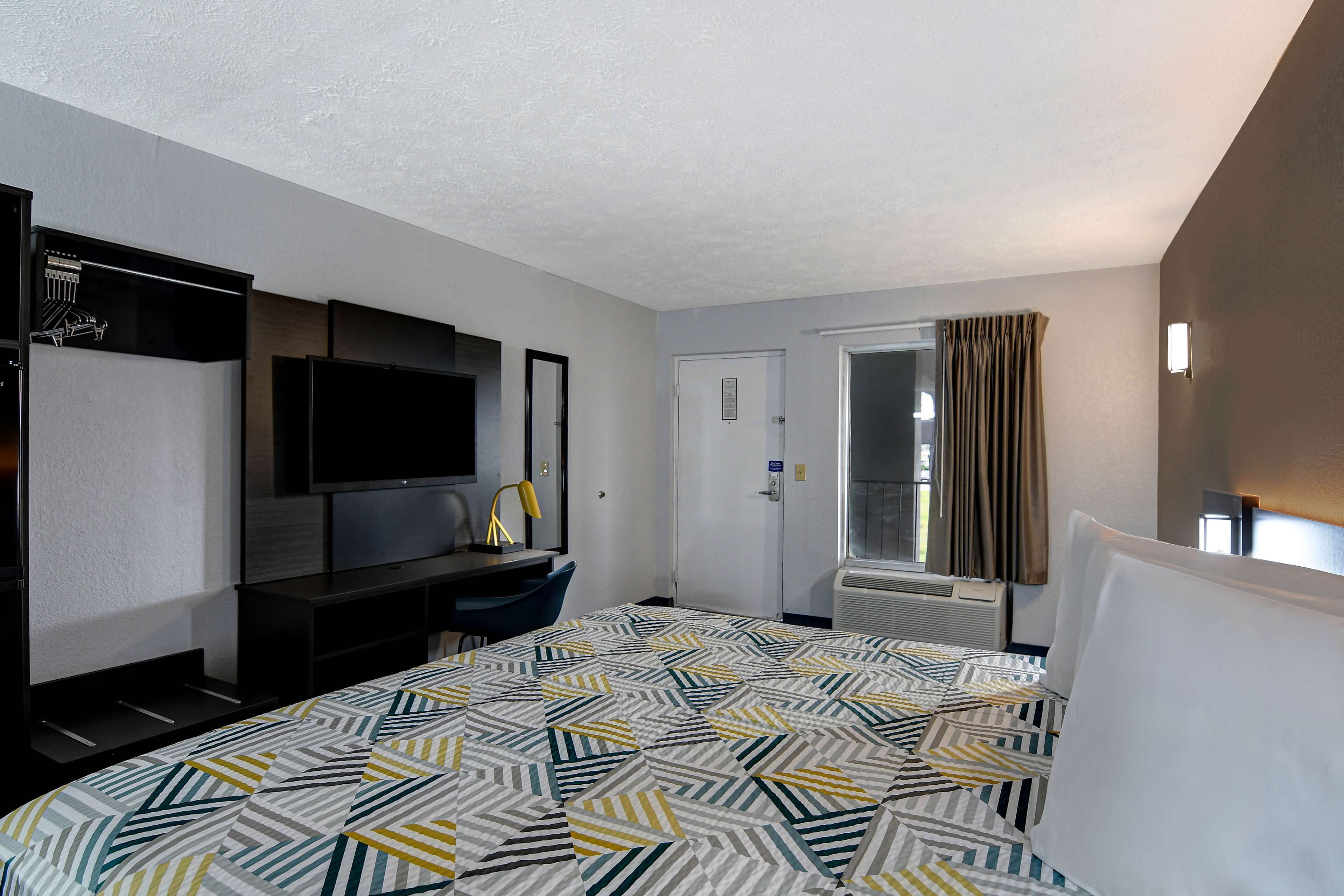 premium bedding, desk, laptop workspace, blackout curtains