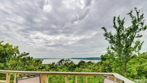 A deck with a table and chairs overlooking a body of water and greenery. - Enchanting Memory Maker-Treetop Hideaway-Jacuzzi (Stigler)
