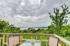 A deck with a table and chairs overlooking a body of water and greenery. - Enchanting Memory Maker-Treetop Hideaway-Jacuzzi (Stigler)