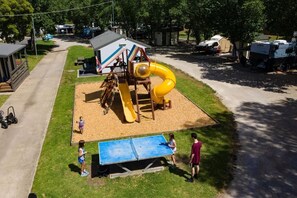 A playground with a slide and a table tennis table. - Geelong Holiday Park (Belmont)