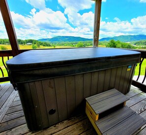 A hot tub on a wooden deck with a view of green hills and a clear sky. - Mountain Views & Tranquil Surroundings.  Hot Tub! (Fletcher)