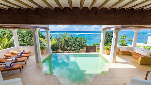 A pool area with lounge chairs and a view of the ocean. - Cinnamon House by The Serendipity Collection (Weligama)
