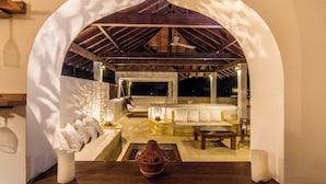 An indoor seating area with a wooden ceiling and a white archway. - Cinnamon House by The Serendipity Collection (Weligama)