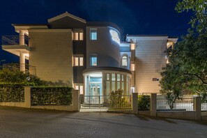 A modern building with a curved entrance, multiple windows, and a gated driveway. - Apartment Gabriel 220m from the beach, Okrug Gornji, Croatia (Okrug Gornji)