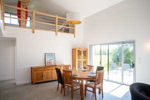 A dining area with a wooden table, chairs, and a glass cabinet.