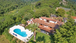 A villa with a swimming pool, surrounded by lush greenery and hills. - PREMIUM HABITAT CAN FERRER (Arenys de Munt)