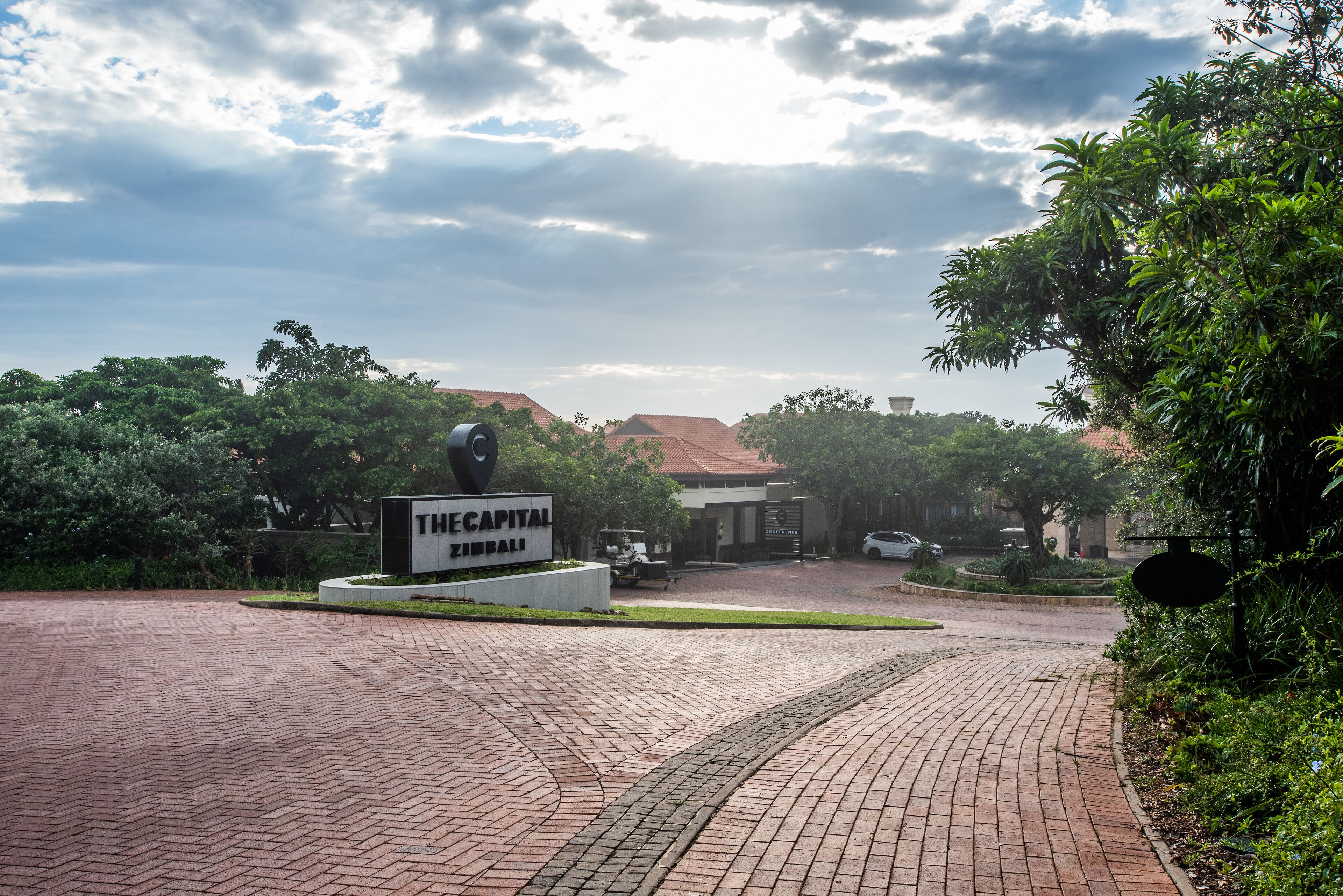 A paved entrance with a sign reading "The Capital Building".