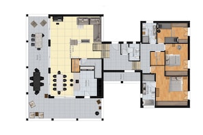 Ein Grundriss eines Hotels mit Essbereich, Küche, mehreren Schlafzimmern, Badezimmern und einem Wohnzimmer.