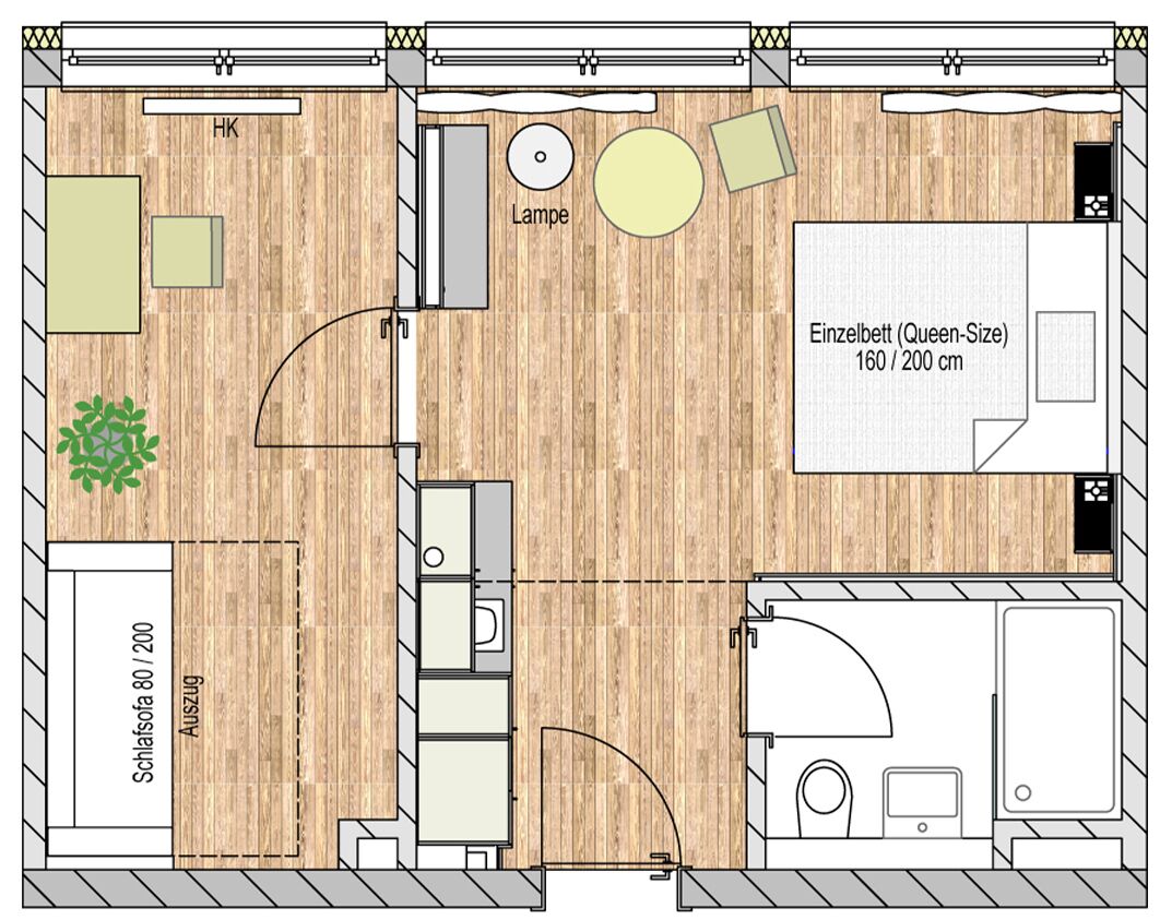 Une chambre d’hôtel comprenant un lit de type « queen-size », une petite salle de bain, un coin salon avec une table et des chaises, et une kitchenette.
