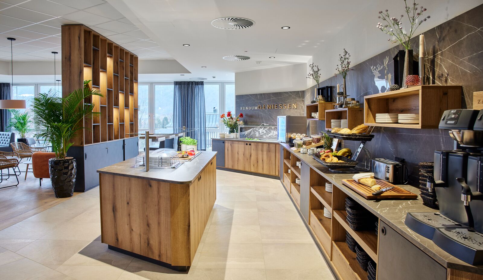 A modern kitchen with wooden cabinetry, a central island, and a coffee station.