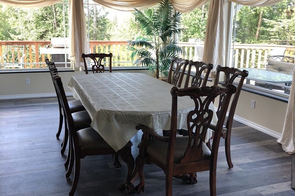 Dining area surrounded by large picture windows.