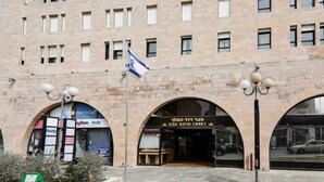 A building with multiple storefronts, including a jewelry store and a car rental service. - King David Elegance - Two Bedroom Apartment, Sleeps 4 (Jerusalem)
