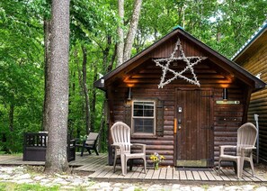 A log cabin with a star decoration on the roof, two chairs outside, and a sign that reads "BUNNY HILL". - Three lovely Cabins nestled in the woods one minute from Sugarbush Resort (Warren)