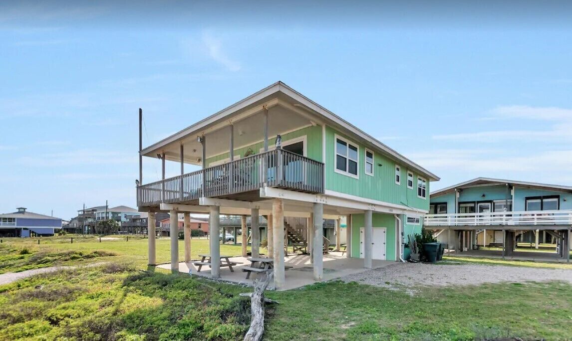 Beach house has open lots on both sides providing expansive views down the beach