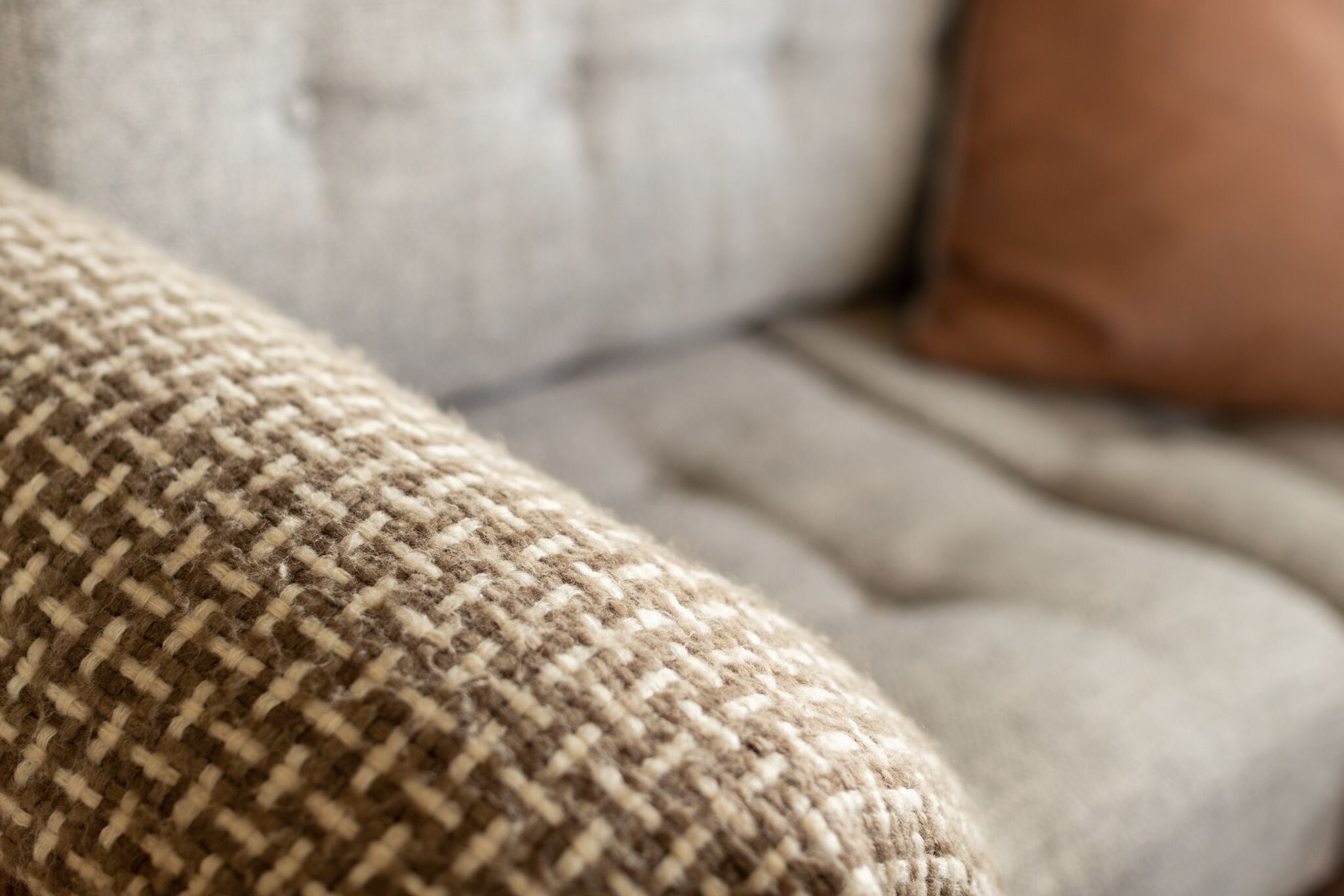 A close-up of a textured fabric, likely part of a sofa or chair upholstery.
