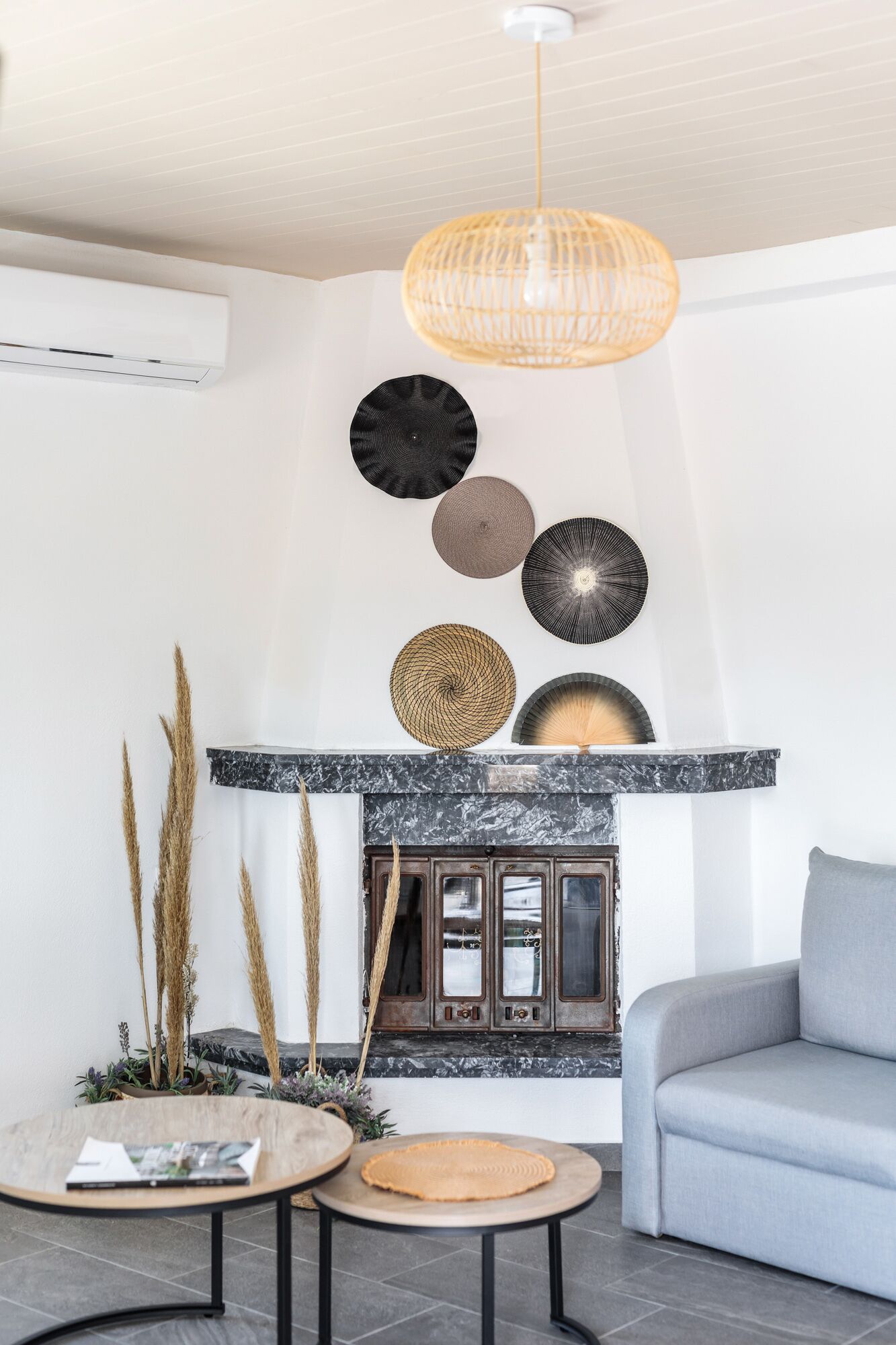 A modern living room with a fireplace, a sofa, and decorative wall art.